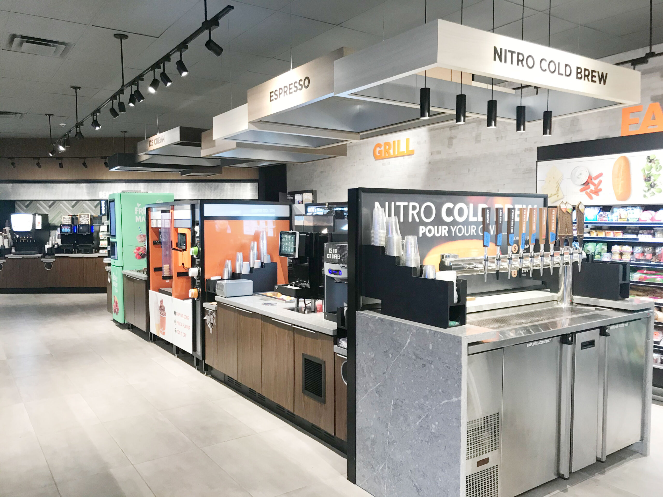 Integrated convenience store foodservice environment with beverage equipment, custom cabinetry and merchandising.